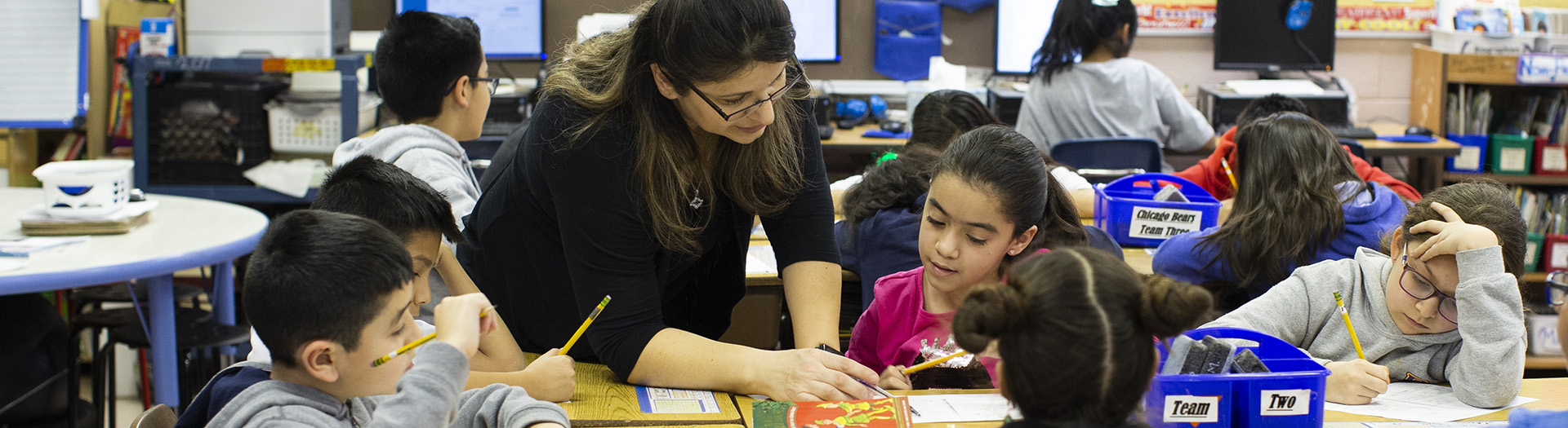 Teacher helping students