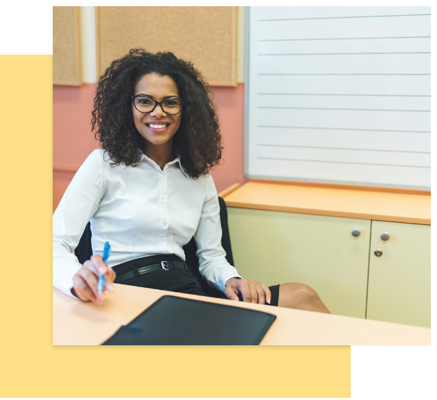 Woman at desk smiling.