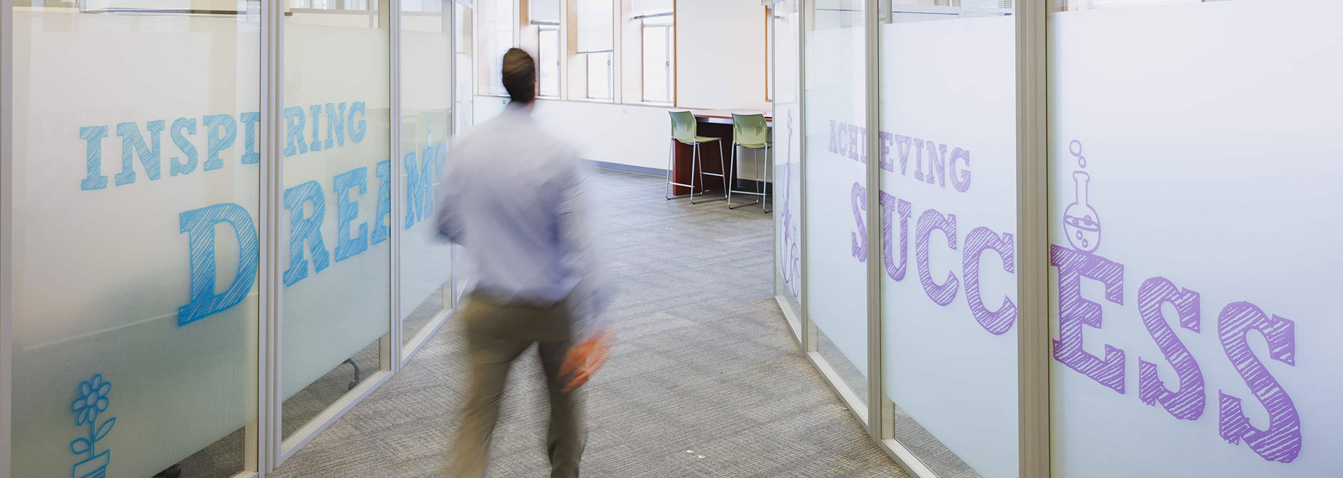 Man walking in hallway.